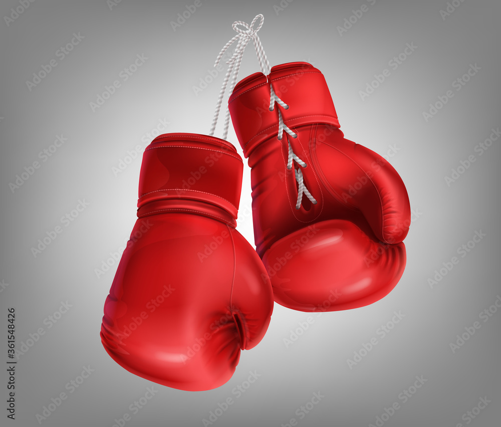 Realistic red pair of leather boxing gloves hanging on laces. Protective sport equipment in fist fight, sparring, fisticuffs or combat. Sportswear for a kick workout, training hit with a punching bag.