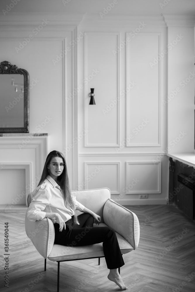 girl smiles and sits in a chair girl smiles and sits in a chair