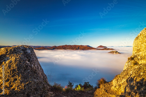 Mountain peaks over misty autumn landscape. Morning inversion in the Sulov rock mountains, Slovakia Europe.