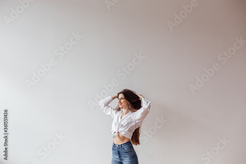 Portrait of a beautiful girl enjoying life standing against the wall
