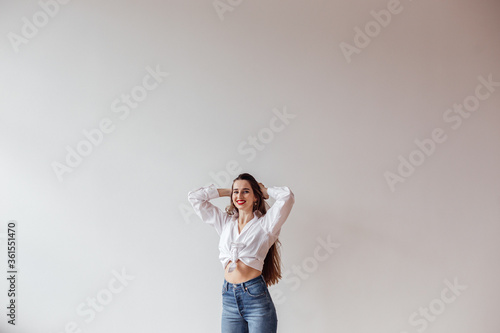 Portrait of a beautiful girl enjoying life standing against the wall