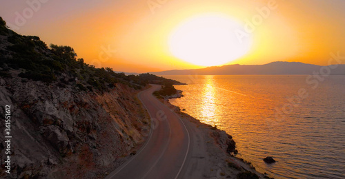 AERIAL: Scenic drone view of an empty coastal road in breathtaking Dalmatia.