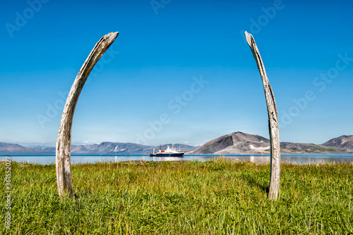 Tourist boat anchored in front of Ittygran Island, Chukotka, Russia photo