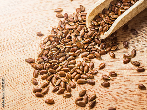 Flax seeds in a wood spoon on a wooden background..Linseed in scoop.