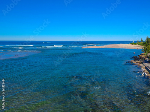 Drone Aerial view of The Entrance NSW Australia blue bay waters great beach and sandy bars © Elias Bitar