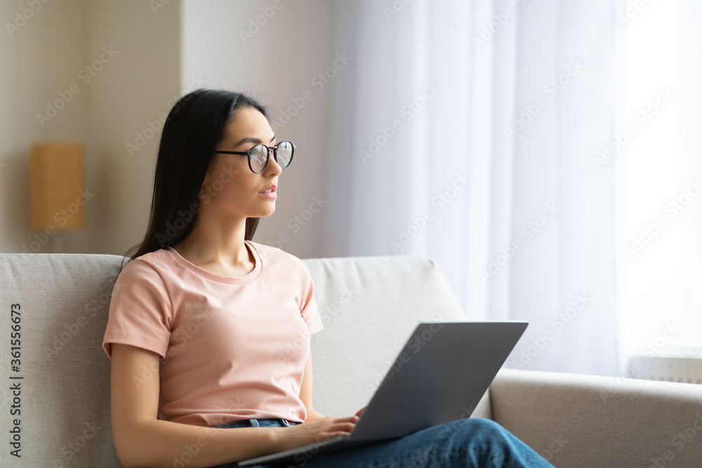 Woman Working On Laptop Thinking Sitting On Couch At Home Woman Working On Laptop Thinking Sitting On Couch At Home