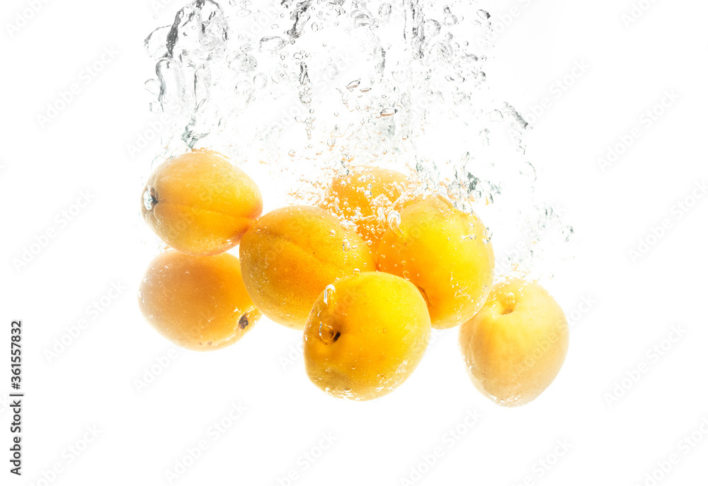 Bunch of apricots splashing in the clear water with air bubbles Bunch of apricots splashing in the clear water with air bubbles
