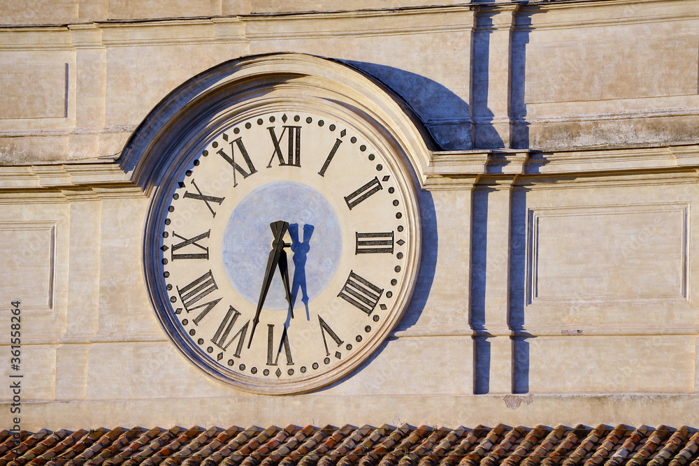 Old wall clock, side lighted in the afternoon