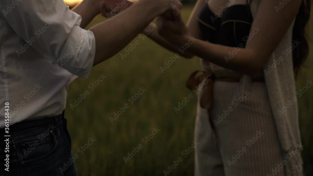 Slow motion shot of couple dancing outdoors and holding hands Slow motion shot of couple dancing outdoors and holding hands