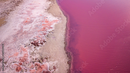Scenic colorful Pink Salt Lake in Ukraine. unusual color cause of an algae with red pigments. Amazing seascape.