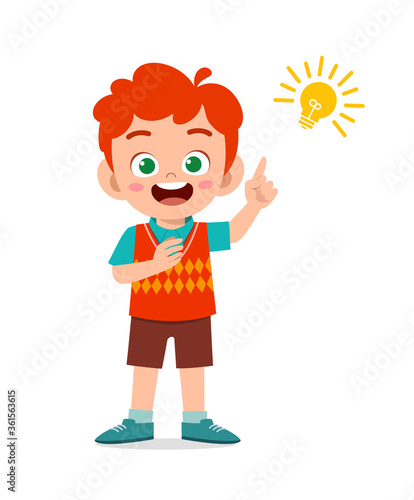 happy cute little kid boy with idea lamp sign