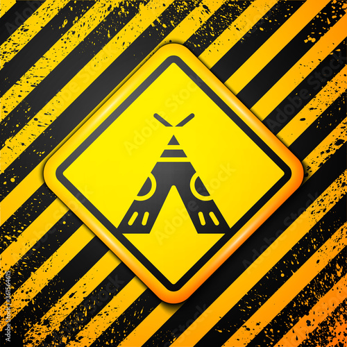 Black Traditional indian teepee or wigwam icon isolated on yellow background. Indian tent. Warning sign. Vector Illustration.