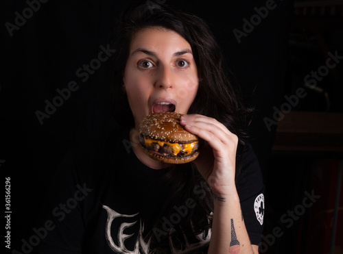 beautiful girl eating cheeseburger