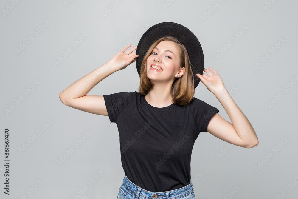 Gorgeous young woman in black floppy hat posing isolated on white background Gorgeous young woman in black floppy hat posing isolated on white background