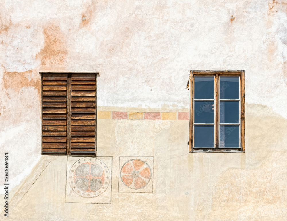 Wall and windows of an old medieval house on the street of the ancient city of Cesky Krumlov in the Czech Republic