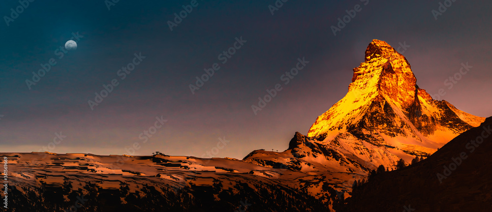 Panoramic mountain landscape with views of the Matterhorn peak in Pennine alps during sunrise, Switzerland.