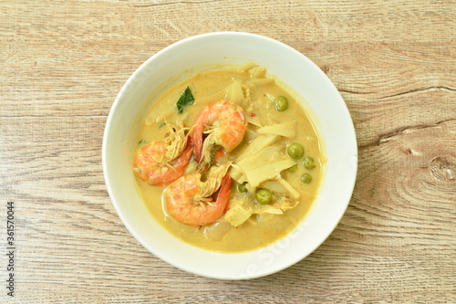 spicy boiled slice pickled bamboo shoot with shrimp and eggplant in coconut milk curry soup on bowl