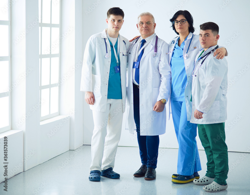 Successful medical team. Confident doctors team standing together and smiling Successful medical team. Confident doctors team standing together and smiling