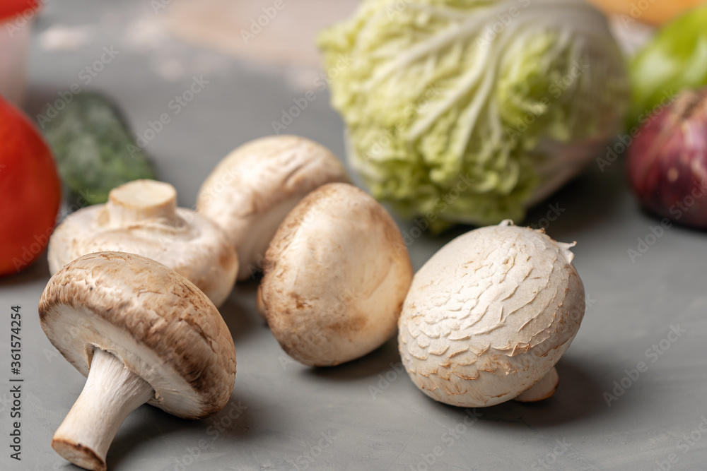 Mushrooms are on the kitchen table among the vegetables Mushrooms are on the kitchen table among the vegetables