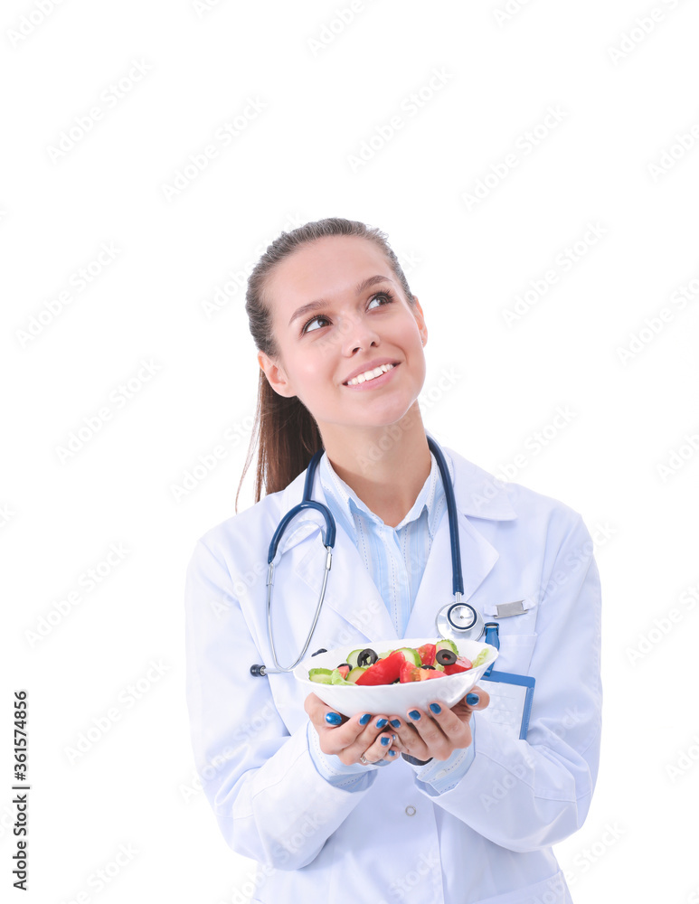 Portrait of a beautiful woman doctor holding a plate with fresh vegetables. Woman doctors. Portrait of a beautiful woman doctor holding a plate with fresh vegetables. Woman doctors.