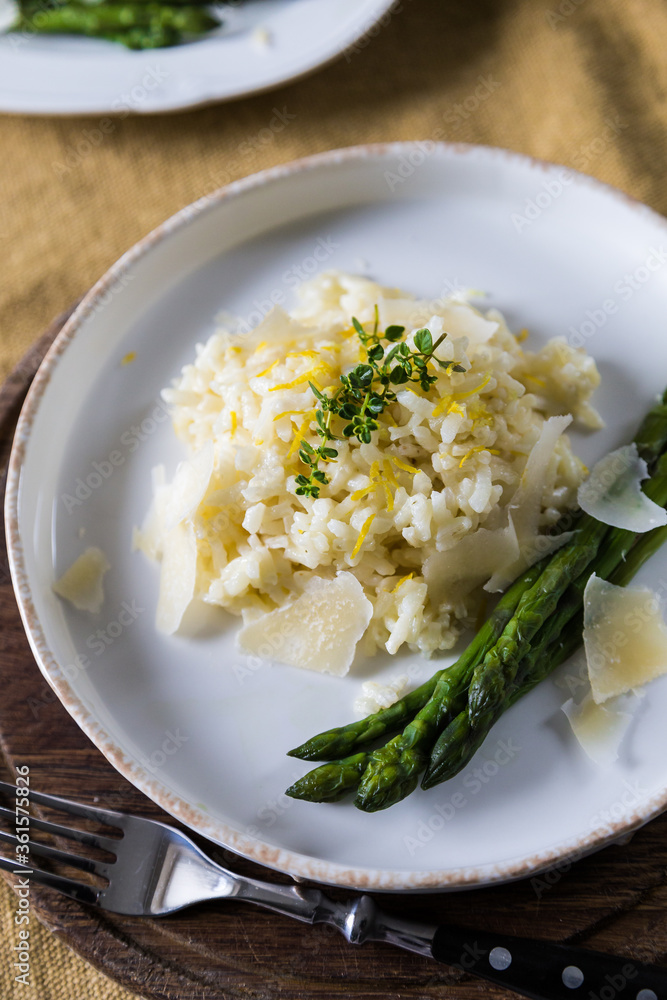 Creamy lemon risotto with parmesan and asparagus on white plate. Creamy lemon risotto with parmesan and asparagus on white plate.