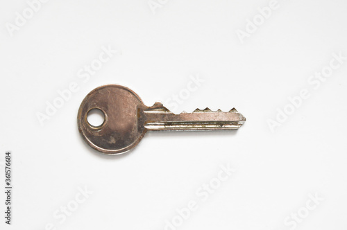 the key to the front door. metal key on a white background. © Alena Mostovich