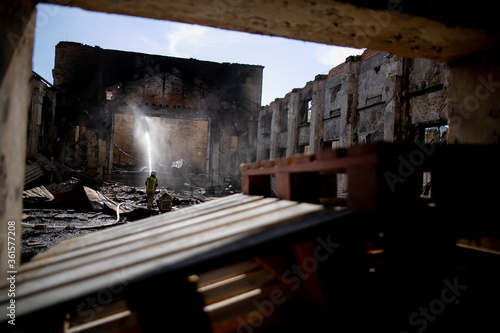 Burned house interior after fire, ruined building room inside, disaster or war aftermath