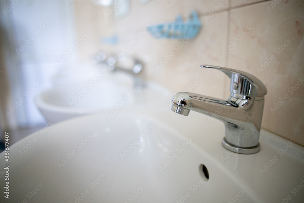 Bathroom interior with white sink and faucet Bathroom interior with white sink and faucet