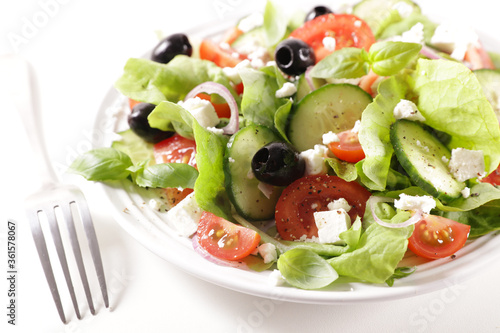 plate of mixed salad with tomato, olive, cucumber and feta cheese