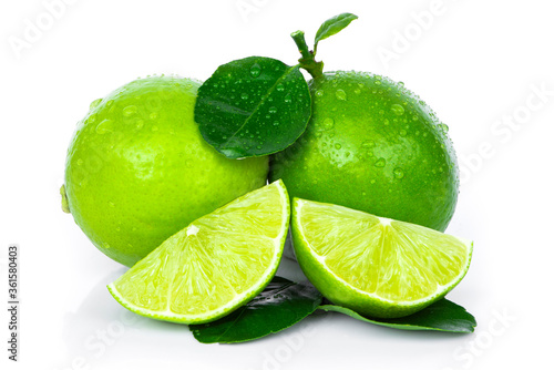 Fresh Lime fruits with green leaf and cut in half slice isolated on white background. 