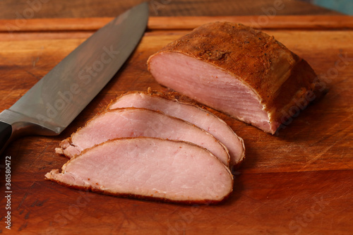 Canadian bacon, smoked pork loin, sliced on table