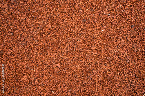 Background of brown sandy ground full of pebbles.  © rivermartin