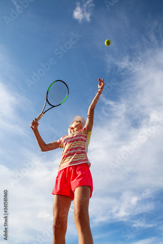 Young tennis girl is getting ready to serve. Professional sport. © Pitcher