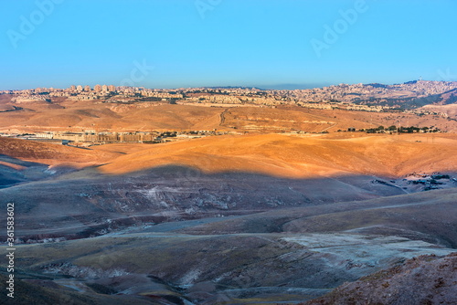 Panorama of the Israeli city of Ma'ale Adumim, Arab village of Bethany/Al-Azariya on the Mount of Olives, the construction site of the new shopping center, and bedouin camp nestled in the desert hills