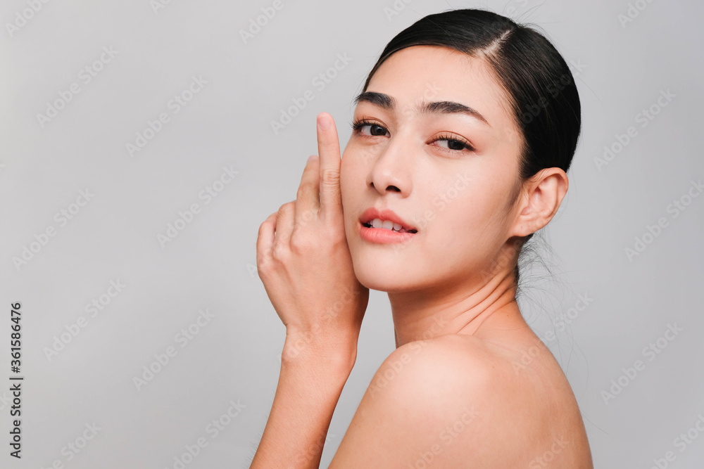 Young beautiful asian woman with clean, fresh and bright skin isolated on gray background,Beauty Cosmetics and Facial treatment Concept Young beautiful asian woman with clean, fresh and bright skin isolated on gray background,Beauty Cosmetics and Facial treatment Concept