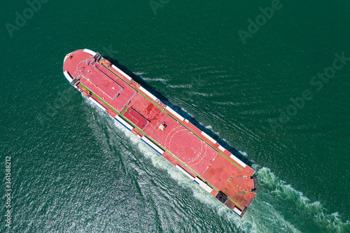 Aerial view of the huge ro-ro ship loading new cars. Automotive container carriers sailing on the sea © SHUTTER DIN