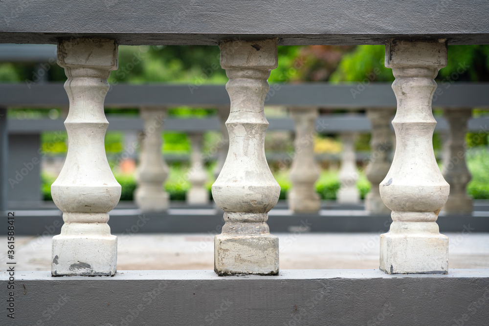 Fototapeta premium Close-up at row of stone pillar balcony of walkway in European luxury mansion. Gardening outdoor decoration object photo.