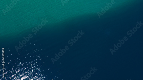 Aerial view of a forest lake. Aerial view of the blue lake and green forests on a sunny summer day. Top view of Patagonia.