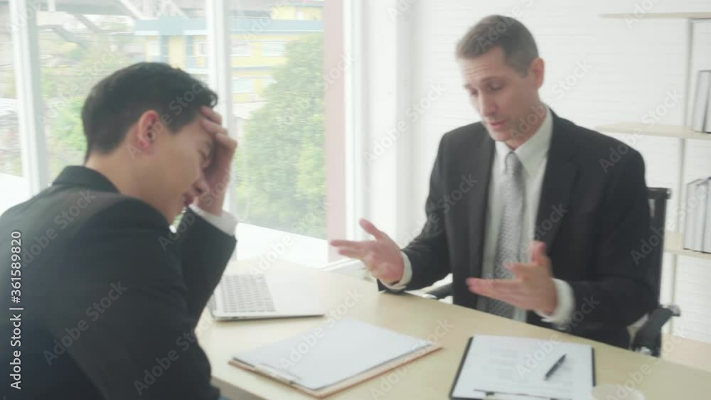 Young asian business man with applicant job interview having stress and sad at the office, manager reading resume unsatisfied and disagree with man, candidate with failure, businessman fail in work. Young asian business man with applicant job interview having stress and sad at the office, manager reading resume unsatisfied and disagree with man, candidate with failure, businessman fail in work.