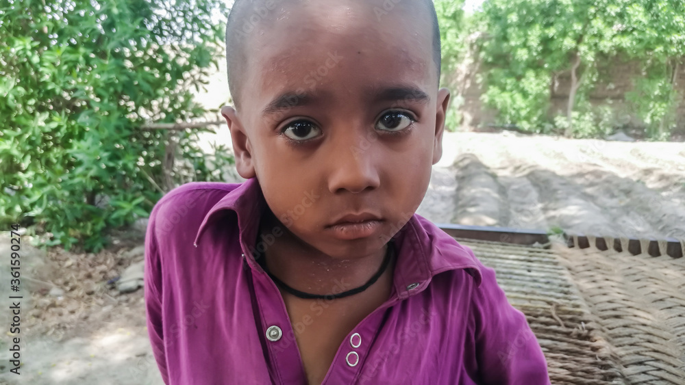 closeup of a poor staring hungry orphan boy in a refugee camp with sad expression on his face and his face and clothes are dirty and his eyes are full of pain closeup of a poor staring hungry orphan boy in a refugee camp with sad expression on his face and his face and clothes are dirty and his eyes are full of pain