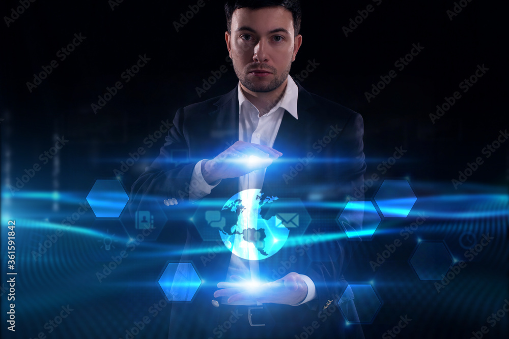 Business, Technology, Internet and network concept. Young businessman working on a virtual screen of the future and sees the inscription: Business, Technology, Internet and network concept. Young businessman working on a virtual screen of the future and sees the inscription: