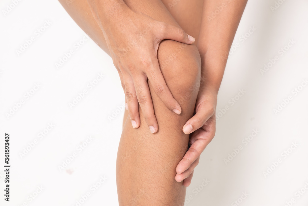 Pain in woman knee. Female holding hands on spot pain , Isolated on white background Pain in woman knee. Female holding hands on spot pain , Isolated on white background