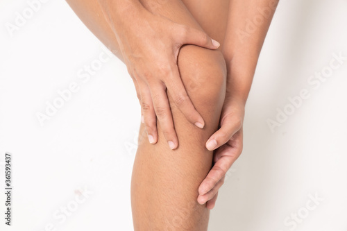 Pain in woman knee. Female holding hands on spot pain   Isolated on white background