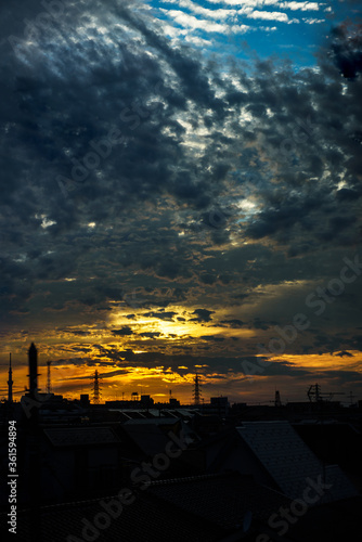 the sunset sky seen outside the window of a train running downtown Tokyo. photo