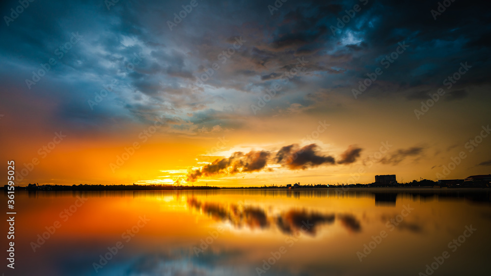 beautiful sunset golden time with industry smoke and water reflection