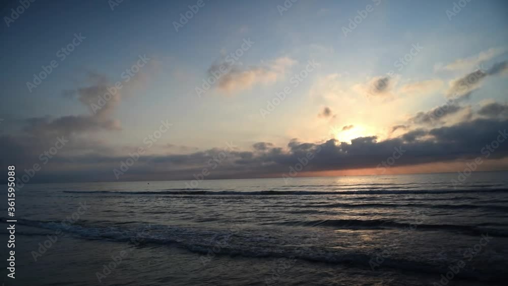 sunrise with clouds on Valencia beach with side view from side to side sunrise with clouds on Valencia beach with side view from side to side