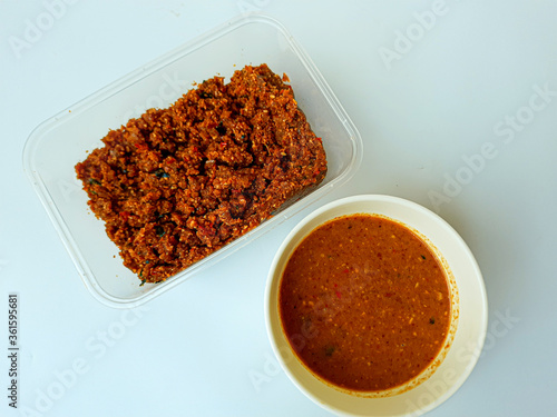 Sambel pecel or peanut sauce from Indonesia, for Indonesian salad. Comparison before and after diluted. Before diluted sauce is mashed solid peanut mixed with spices. photo