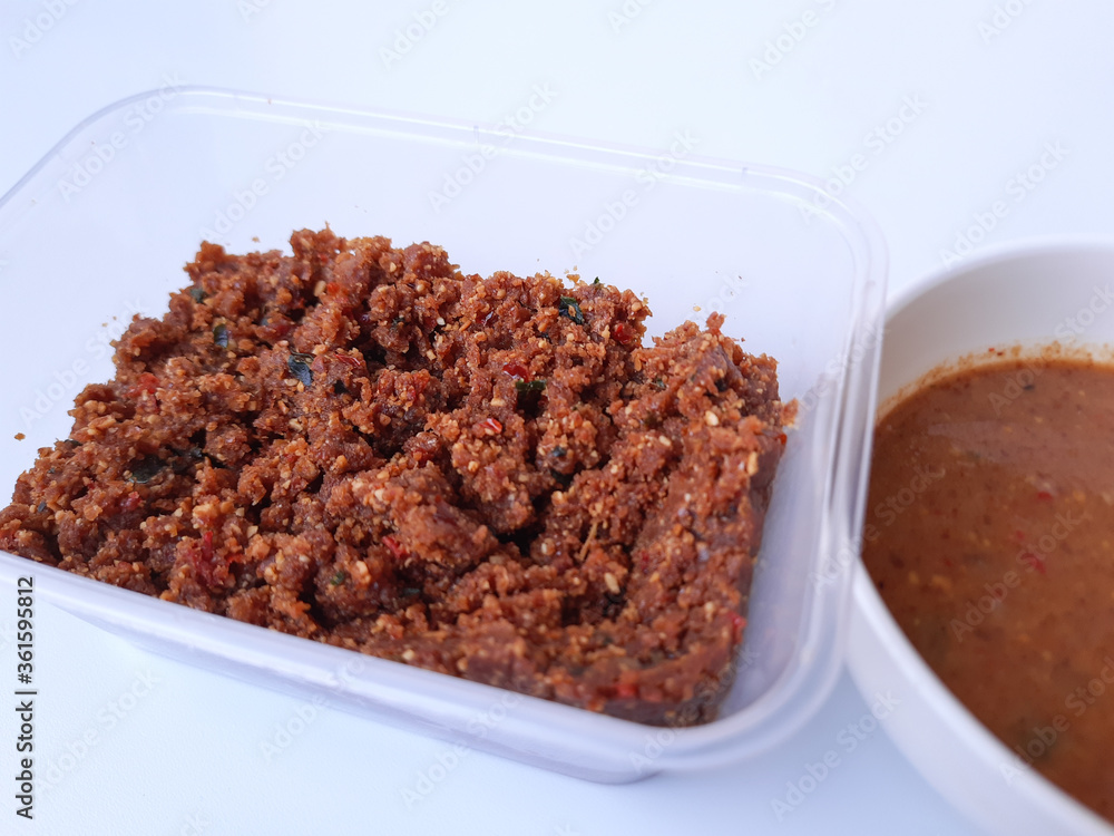 Sambel pecel or peanut sauce from Indonesia, for Indonesian salad. Comparison before and after diluted. Before diluted sauce is mashed solid peanut mixed with spices. Sambel pecel or peanut sauce from Indonesia, for Indonesian salad. Comparison before and after diluted. Before diluted sauce is mashed solid peanut mixed with spices.