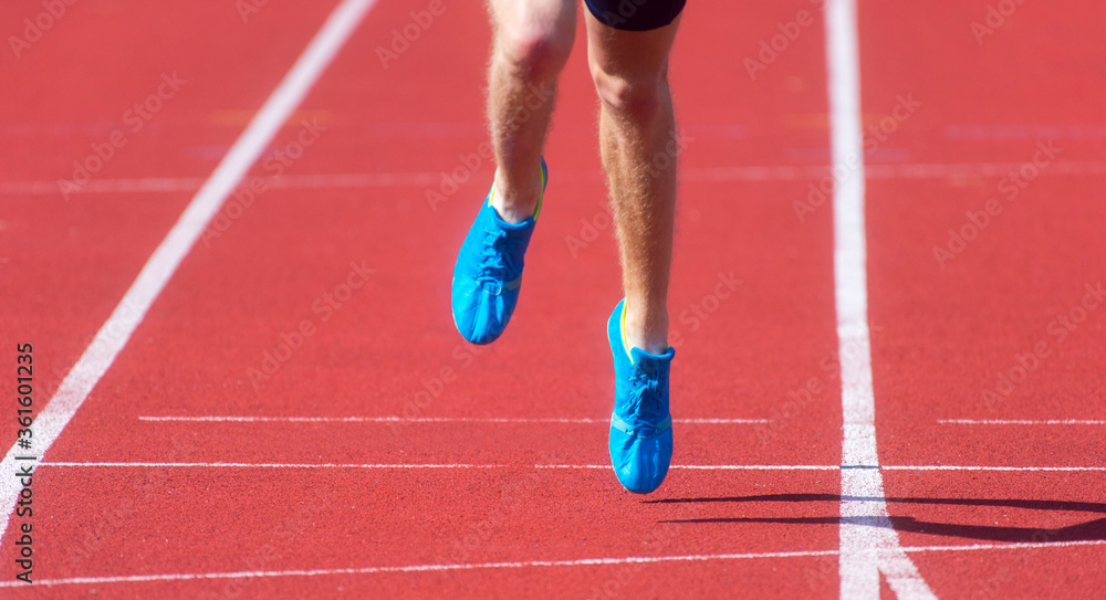 Athletics man running on the track field. Sports and healthy lifestyle concept.