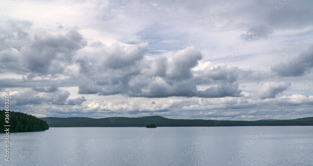 view of the lake and cumulus clouds